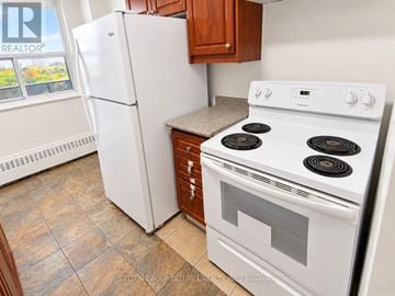 Toronto (Glenfield-Jane Heights) apartment for rent - A white stove and refrigerator in a kitchen.