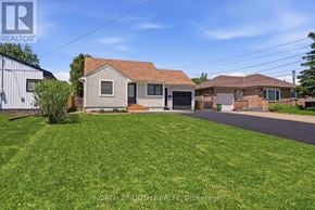 Hamilton (Stoney Creek) apartment for rent - A house with a green lawn is for sale in Brockage.