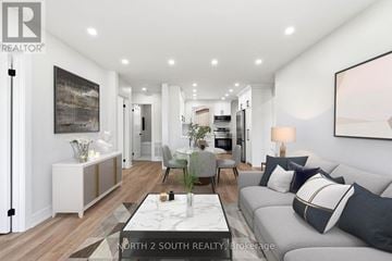 Hamilton (Stoney Creek) apartment for rent - A modern living room with a grey sofa and a coffee table.