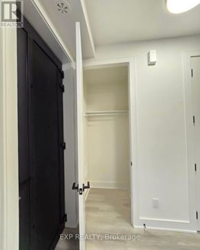 St. Catharines (Oakdale) townhouse for rent - A hallway with a black door on the left and a white door on the right.