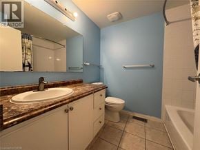 Kitchener townhouse for rent - A bathroom with blue walls and a brown granite countertop.