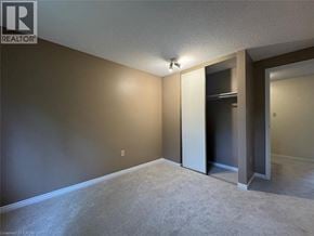 Kitchener townhouse for rent - A room with a carpeted floor and a doorway leading to another room.