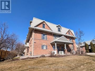 Oshawa (Eastdale) multi-family for rent - A large red brick house with a white roof and a large front porch.