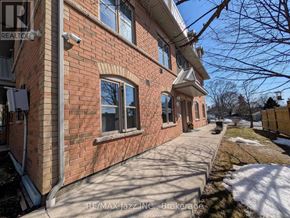 Oshawa (Eastdale) multi-family for rent - A red brick house with a white roof and a snow-covered ground.