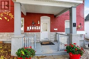 Ottawa multi-family for rent - A red brick house with a white door and a porch.
