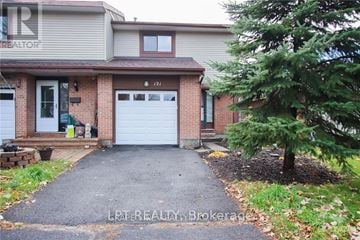 Ottawa apartment for rent - A house with a white garage door is for sale.