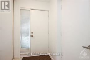 Ottawa apartment for rent - A white door with blinds is in a room with a brown rug.