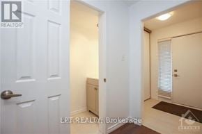 Ottawa apartment for rent - A white door with a handle and a small cabinet underneath it.