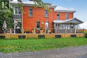 Ottawa apartment for rent - A red brick house with a wooden deck in front.
