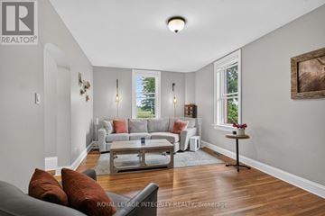 Ottawa apartment for rent - A living room with a grey couch and a wooden floor.