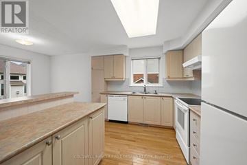Ottawa townhouse for rent - A kitchen with wooden cabinets and a white refrigerator.