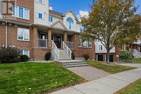 Ottawa townhouse for rent - A brick apartment building with a tree in front.