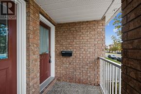 Ottawa townhouse for rent - A red door is on the left side of a brick wall.