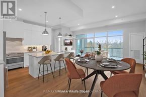 St. Catharines (Downtown) condo for rent - A modern kitchen with a dining table set for four.