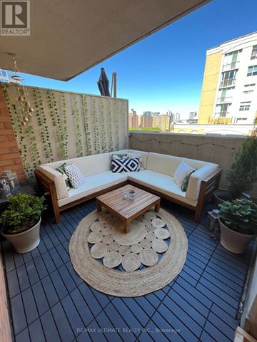 Toronto (Moss Park) condo for rent - A patio with a couch, table, and potted plants.