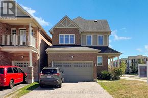 Pickering (Duffin Heights) apartment for rent - A house with a red car and a grey car parked in front.