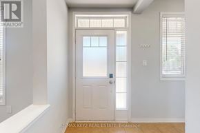 Pickering (Duffin Heights) apartment for rent - A white door with a glass panel is in the center of a room with white walls.