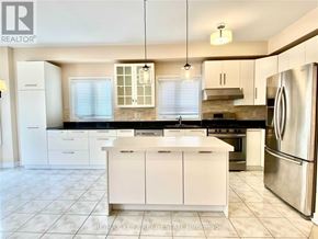 Richmond Hill (Langstaff) apartment for rent - A modern kitchen with white cabinets and stainless steel appliances.