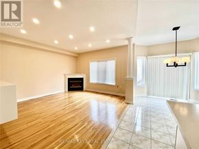 Richmond Hill (Langstaff) apartment for rent - A spacious room with wooden flooring and a fireplace.