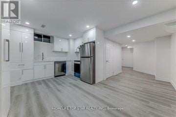 Whitchurch-Stouffville (Stouffville) apartment for rent - A modern kitchen with white cabinets and stainless steel appliances.