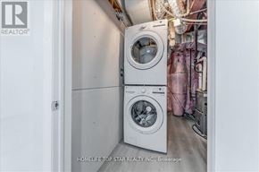 Whitchurch-Stouffville (Stouffville) apartment for rent - A white washing machine and dryer in a small laundry room.