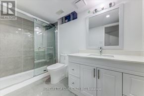 Whitchurch-Stouffville (Stouffville) apartment for rent - A white bathroom with a glass shower door and a white toilet.