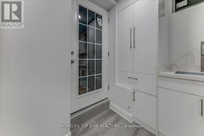 Whitchurch-Stouffville (Stouffville) apartment for rent - A white kitchen with a glass door cabinet and a sink.