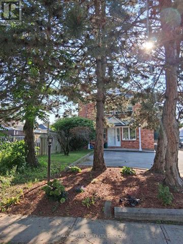 St. Catharines (Downtown) multi-family for rent - A tree-lined street with a house in the background.