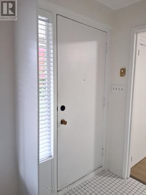 St. Catharines (Downtown) multi-family for rent - A white door with a handle and a keyhole is in a room with white walls.
