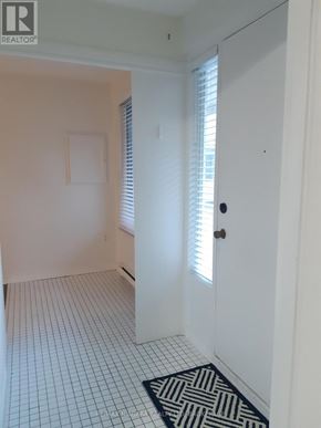 St. Catharines (Downtown) multi-family for rent - A white door with a window above it.