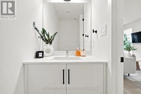 London South (South U) townhouse for rent - A white bathroom with a sink and a mirror.