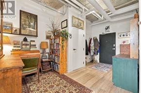 Guelph (St. Patrick's Ward) condo for rent - A room with a bookshelf, a chair, and a rug.
