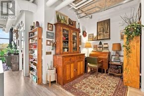 Guelph (St. Patrick's Ward) condo for rent - A room with a wooden cabinet and a rug on the floor.