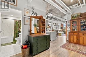 Guelph (St. Patrick's Ward) condo for rent - A room with a green dresser and a mirror on top of it.