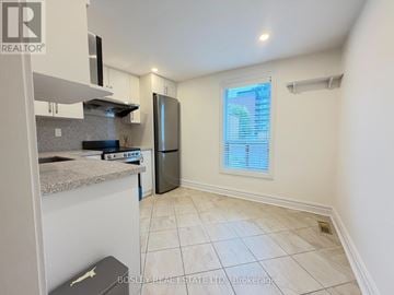 Toronto (Trinity-Bellwoods) townhouse for rent - A kitchen with a refrigerator, microwave, and a countertop.