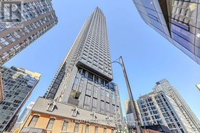 Toronto (Bay Street Corridor) condo for rent - A tall building with a unique triangular top stands out among other buildings.
