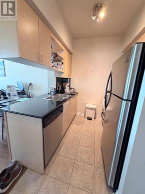 Oakville (Ro River Oaks) condo for rent - A kitchen with a black counter top and a refrigerator.