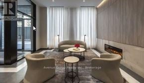 Hamilton (Beasley) condo for rent - A modern living room with a fireplace and a dining table.