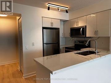 Toronto (Waterfront Communities) condo for rent - A kitchen with white cabinets and a white counter top.