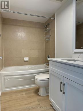 Toronto (Waterfront Communities) condo for rent - A white bathroom with a tub, toilet and sink.