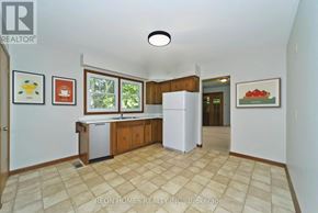 Markham (Box Grove) apartment for rent - A kitchen with a white fridge and cabinets with a tiled floor.