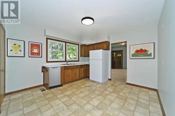 Markham (Box Grove) apartment for rent - A kitchen with a white fridge and cabinets with a tiled floor.