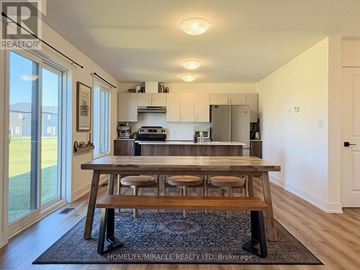 Loyalist (Odessa) apartment for rent - A modern kitchen with a wooden table and stools.