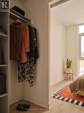 Toronto (Waterfront Communities) condo for rent - A room with a white wall and a hanging coat.
