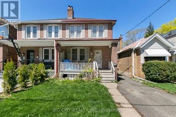 Toronto (Lawrence Park North) apartment for rent - A house with a red brick exterior and a white porch.