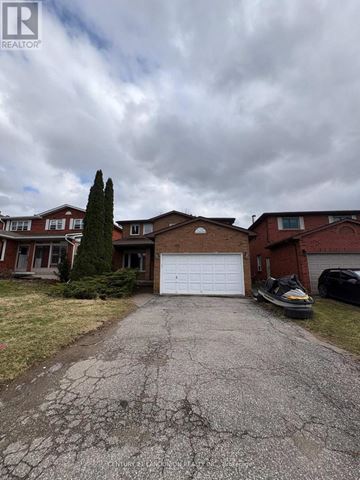 Richmond Hill (Harding) apartment for rent - A realtor photo of a house with a cracked driveway.