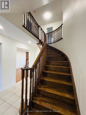 Richmond Hill (Harding) apartment for rent - A wooden staircase with a metal railing.