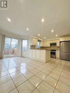 Richmond Hill (Harding) apartment for rent - A spacious kitchen with white cabinets and stainless steel appliances.
