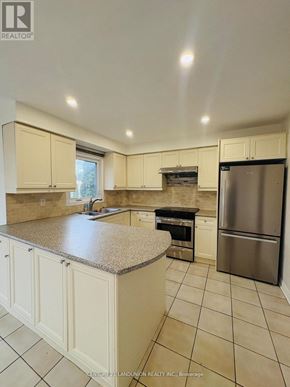 Richmond Hill (Harding) apartment for rent - A kitchen with white cabinets and a granite countertop.