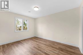 Russell multi-family for rent - A room with a window and wooden flooring.